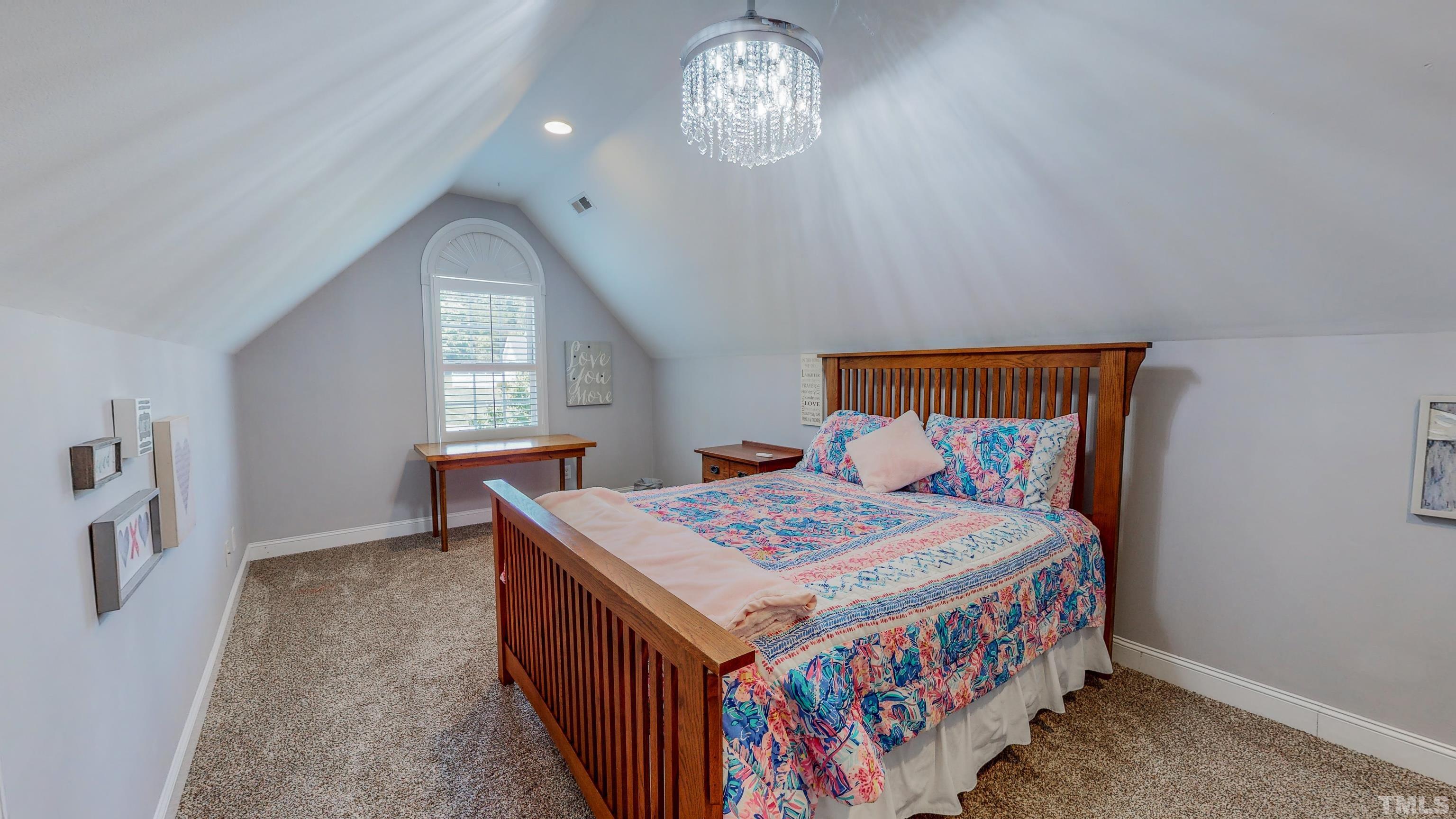 103 Derwin Drive Timberlake, NC 27583 - Photo 40 of 57 a bedroom with a bed and a chandelier