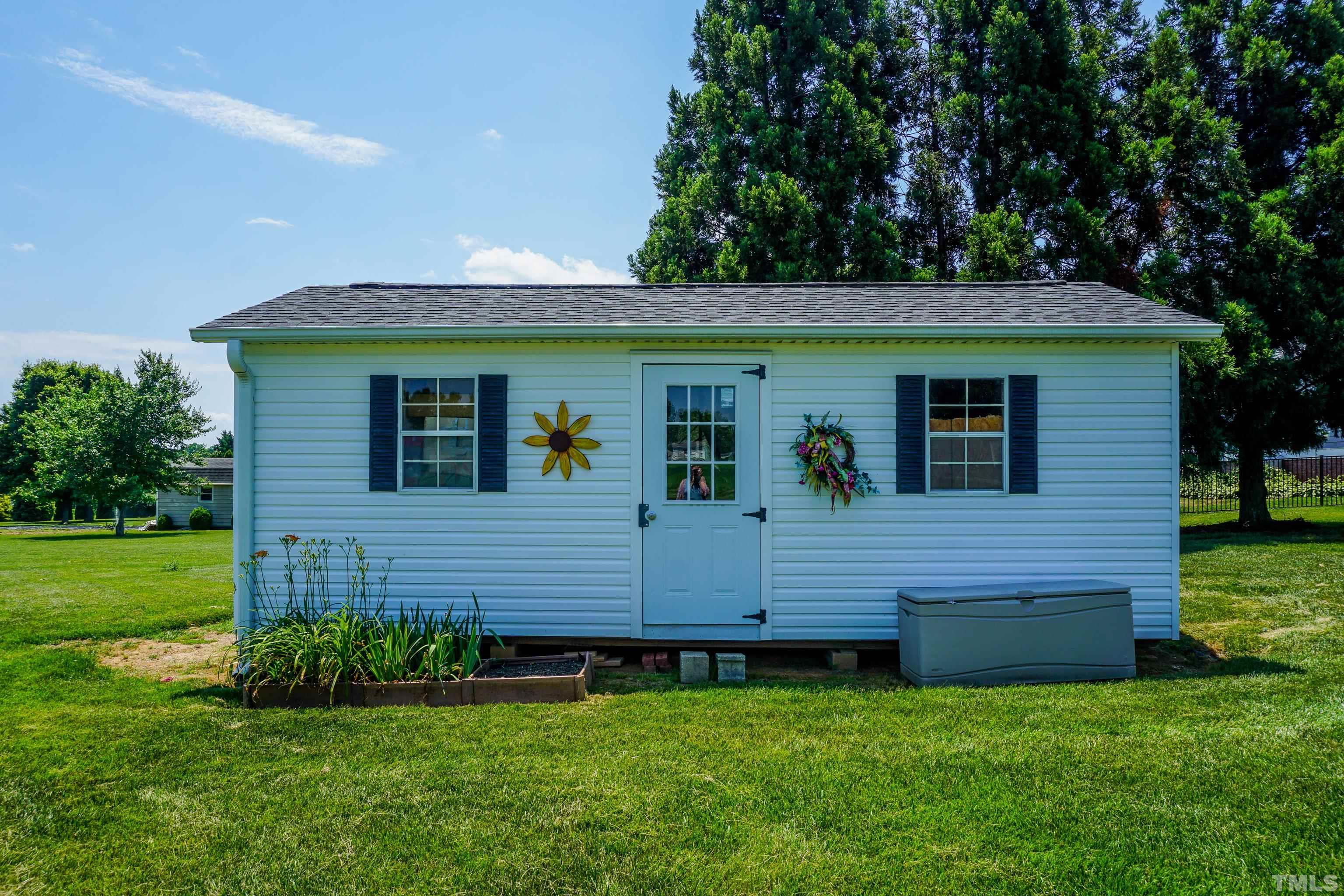 103 Derwin Drive Timberlake, NC 27583 - Photo 43 of 57 a front view of a house with a garden