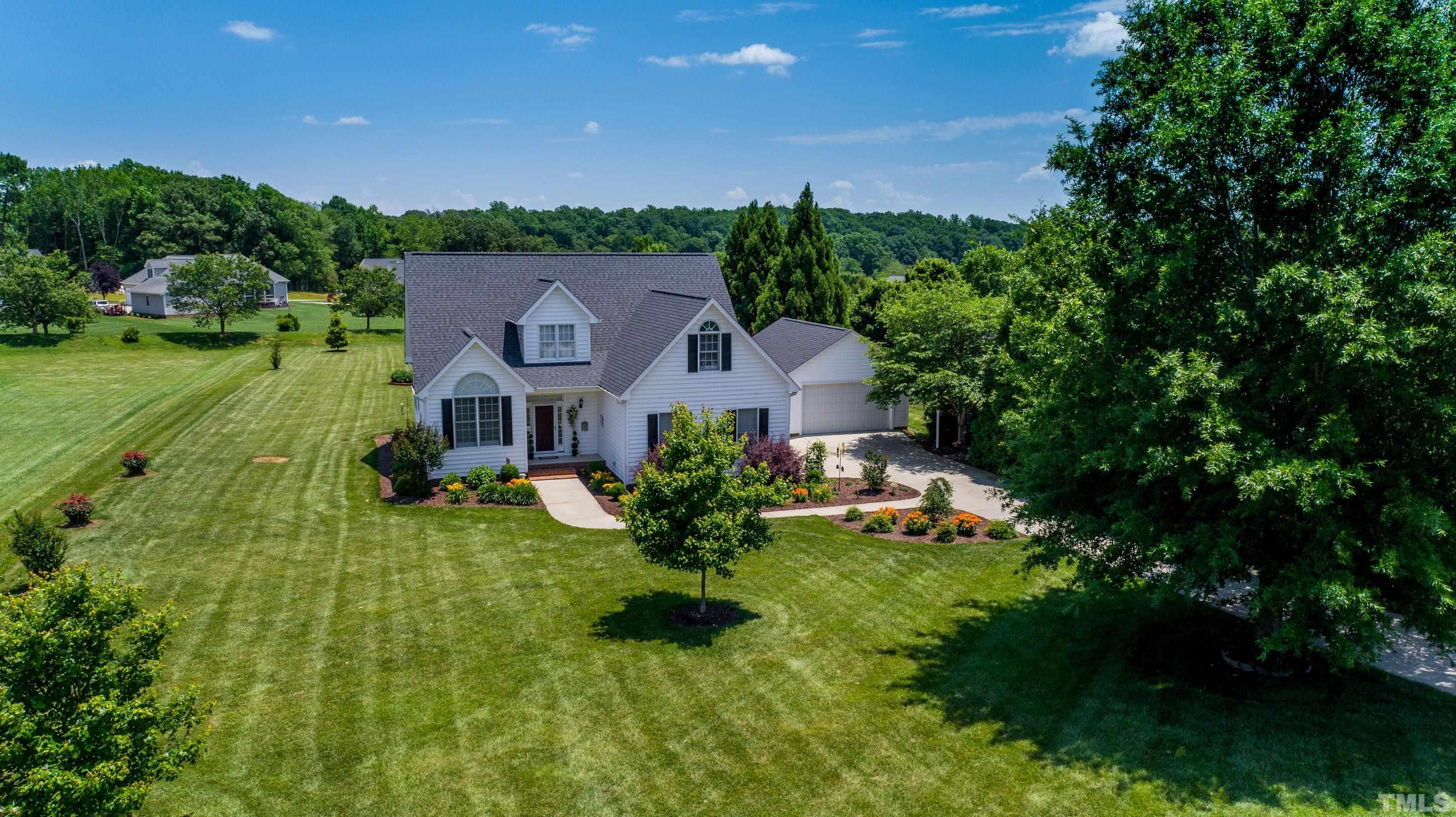 103 Derwin Drive Timberlake, NC 27583 - Photo 48 of 57 a aerial view of a house with a big yard and large trees
