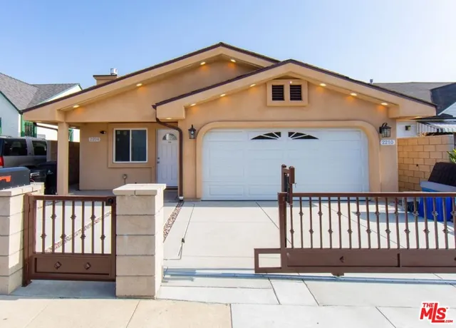 a front view of a house with a fence