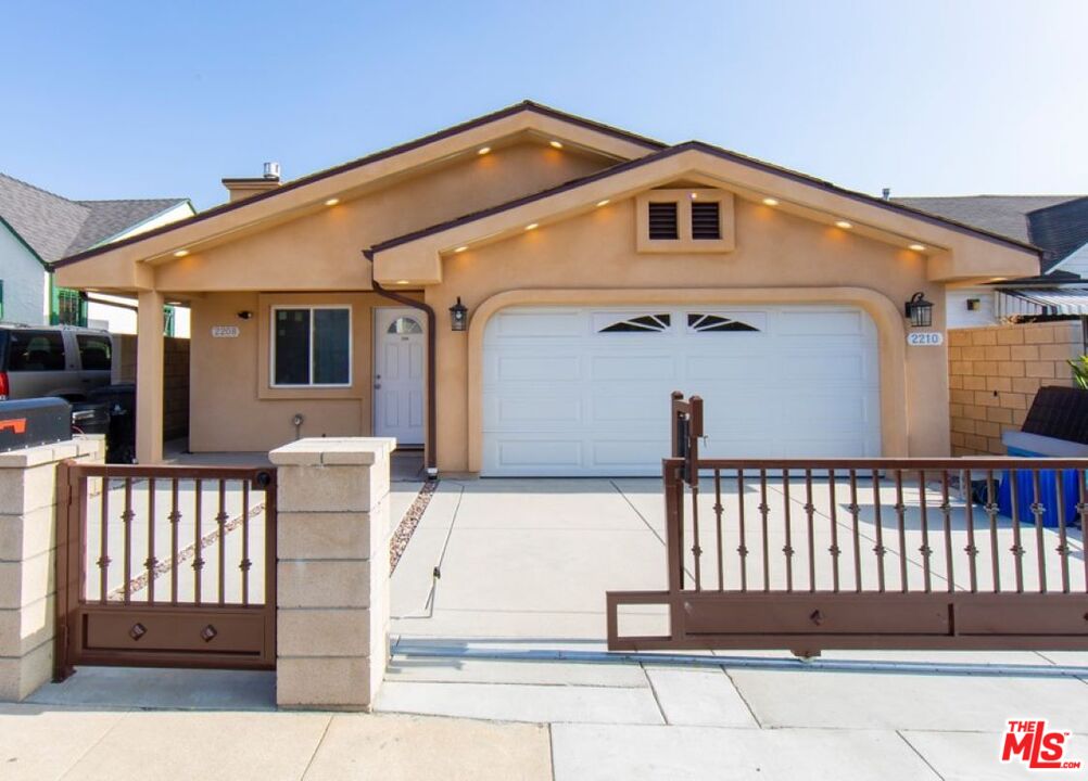 a front view of a house with a fence