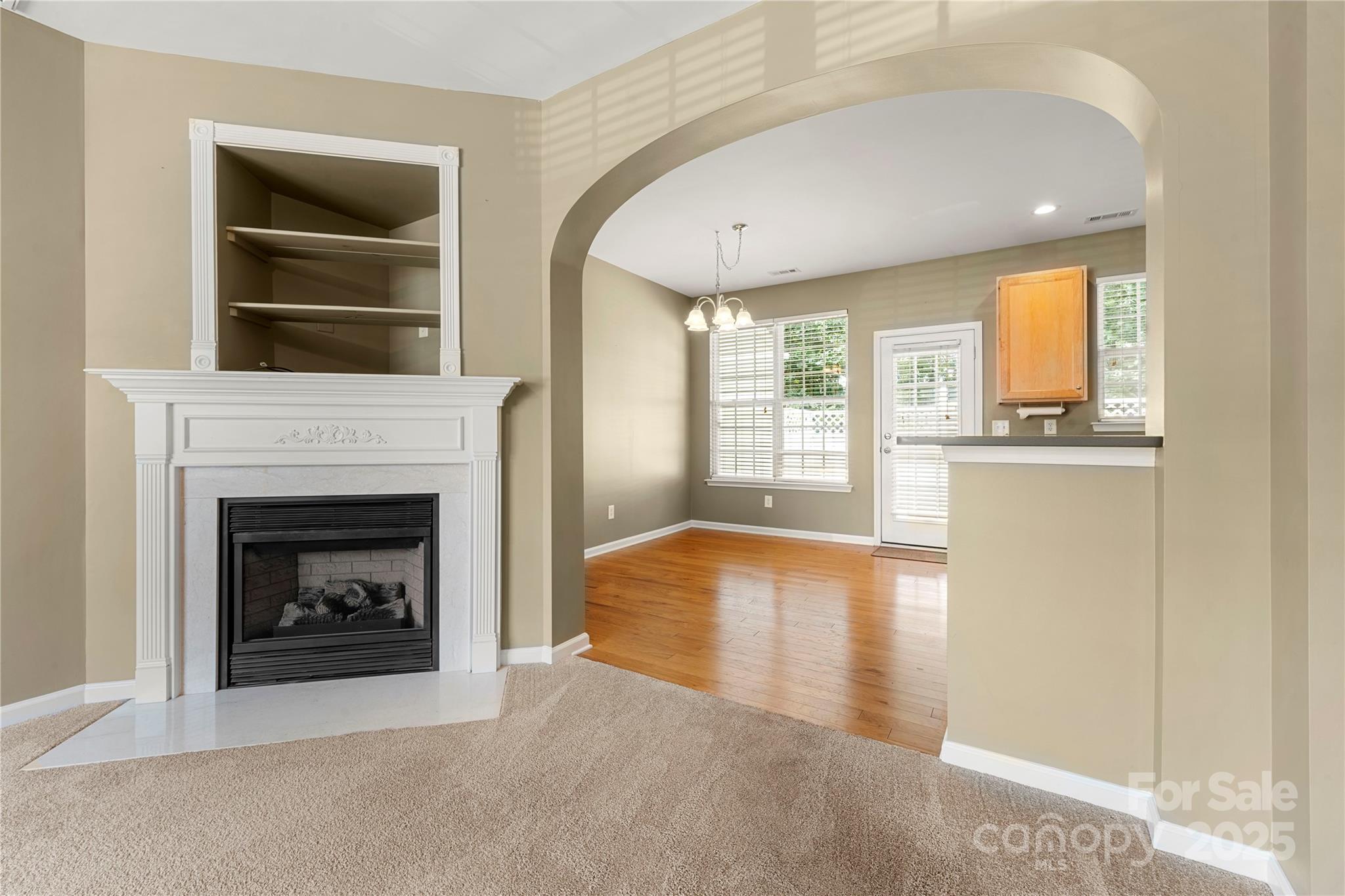 943 Copperstone Lane Fort Mill, SC 29708 - Photo 12 of 37 a living room with a fireplace and a large window