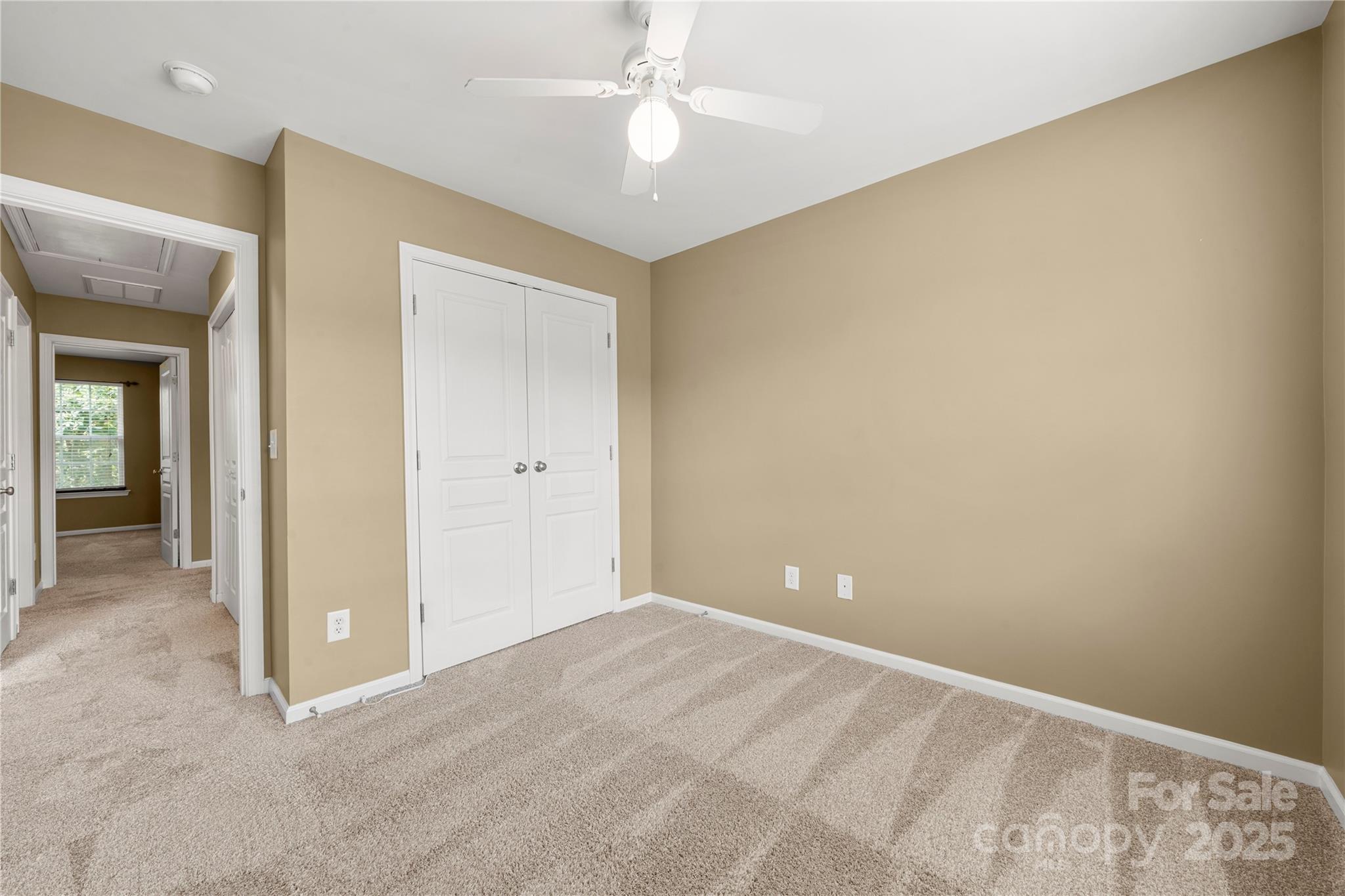 943 Copperstone Lane Fort Mill, SC 29708 - Photo 24 of 37 a view of an empty room with closet and a chandelier fan