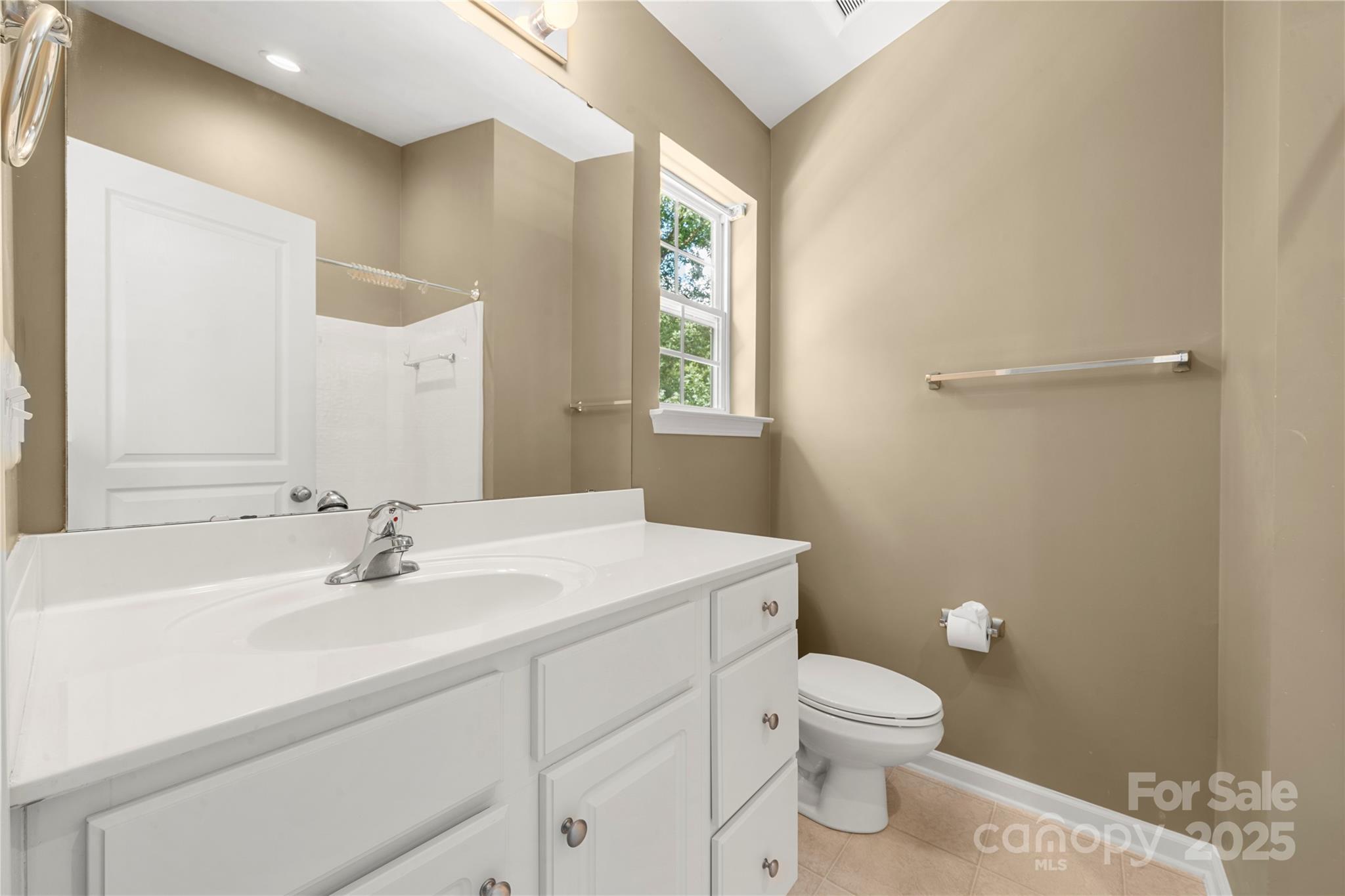 943 Copperstone Lane Fort Mill, SC 29708 - Photo 27 of 37 a bathroom with a sink a toilet and a mirror