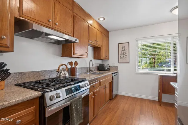 a living room with furniture a flat screen tv and a chandelier