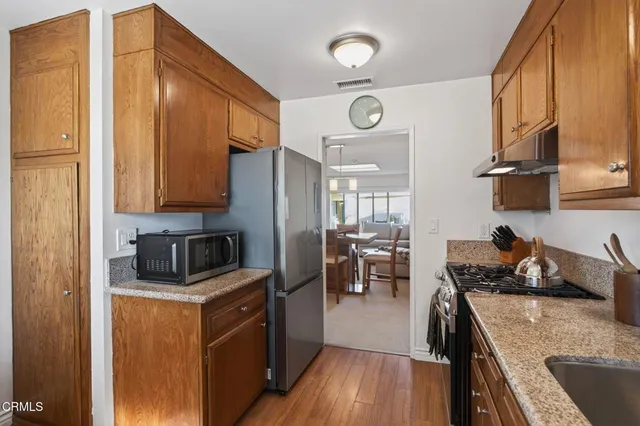 a bathroom with a granite countertop sink and a toilet