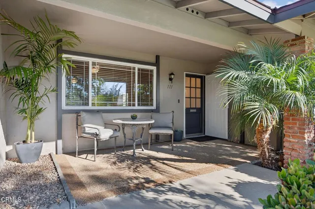a view of a house with a big yard and large trees