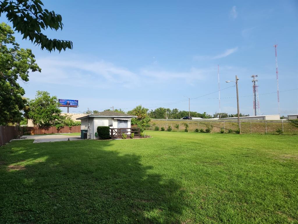 909 Southwest Sw Highway Ocala, FL 34471 - Photo 2 of 19 a view of a house with a big yard and large trees