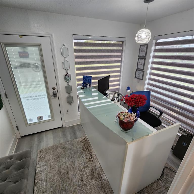 909 Southwest Sw Highway Ocala, FL 34471 - Photo 6 of 19 a view of a room with two chairs and a chandelier