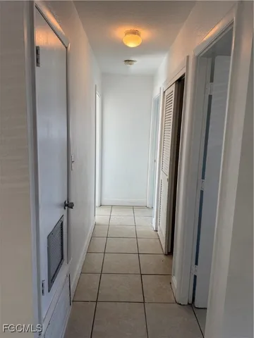 a view of a hallway to rooms