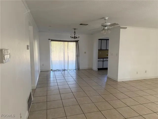 an empty room with closet and windows