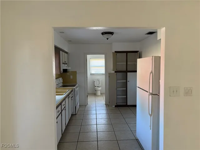 a kitchen with a refrigerator and a sink
