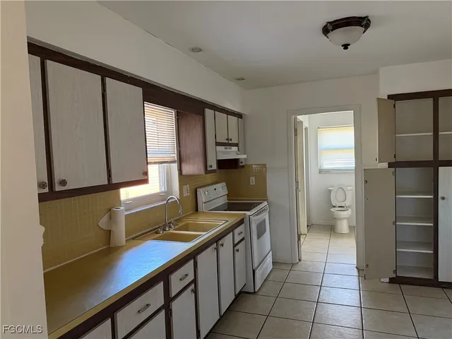 a kitchen with a refrigerator and a sink