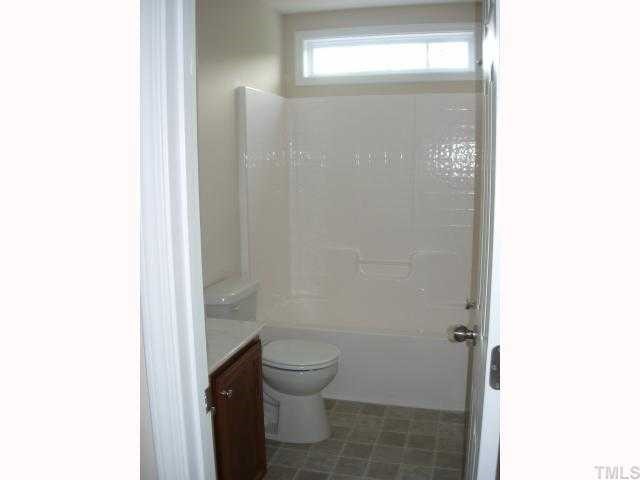 1300 Rushing Creek Parkway Raleigh, NC 27610 - Photo 8 of 12 Hall Bath with great details like transom window over tub and 36" tall vanity.