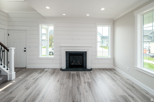 8797 Green Way, Unit 3 Sandy, UT 84094 - Photo 2 of 12 Unfurnished living room with stairs, light wood-style flooring, recessed lighting, healthy amount of natural light, and crown molding