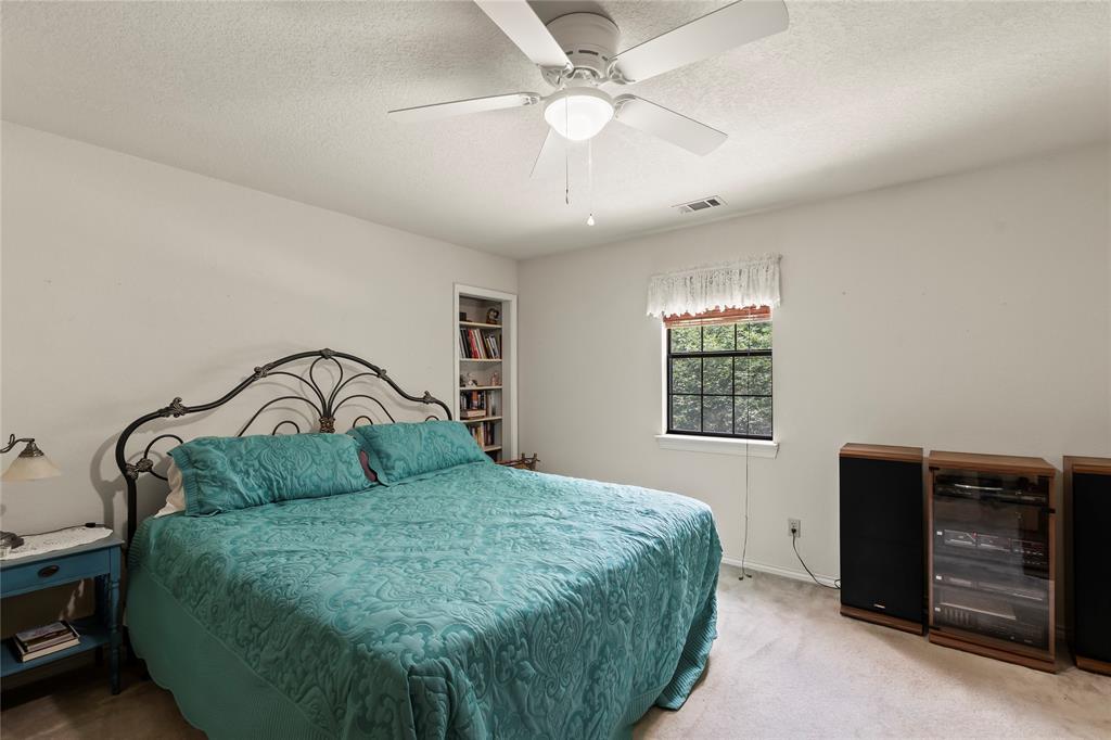 455 Stirrup Ranch Road Trinidad, TX 75163 - Photo 15 of 20 a bedroom with a bed and a ceiling fan