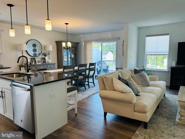 a living room with furniture a window and appliances