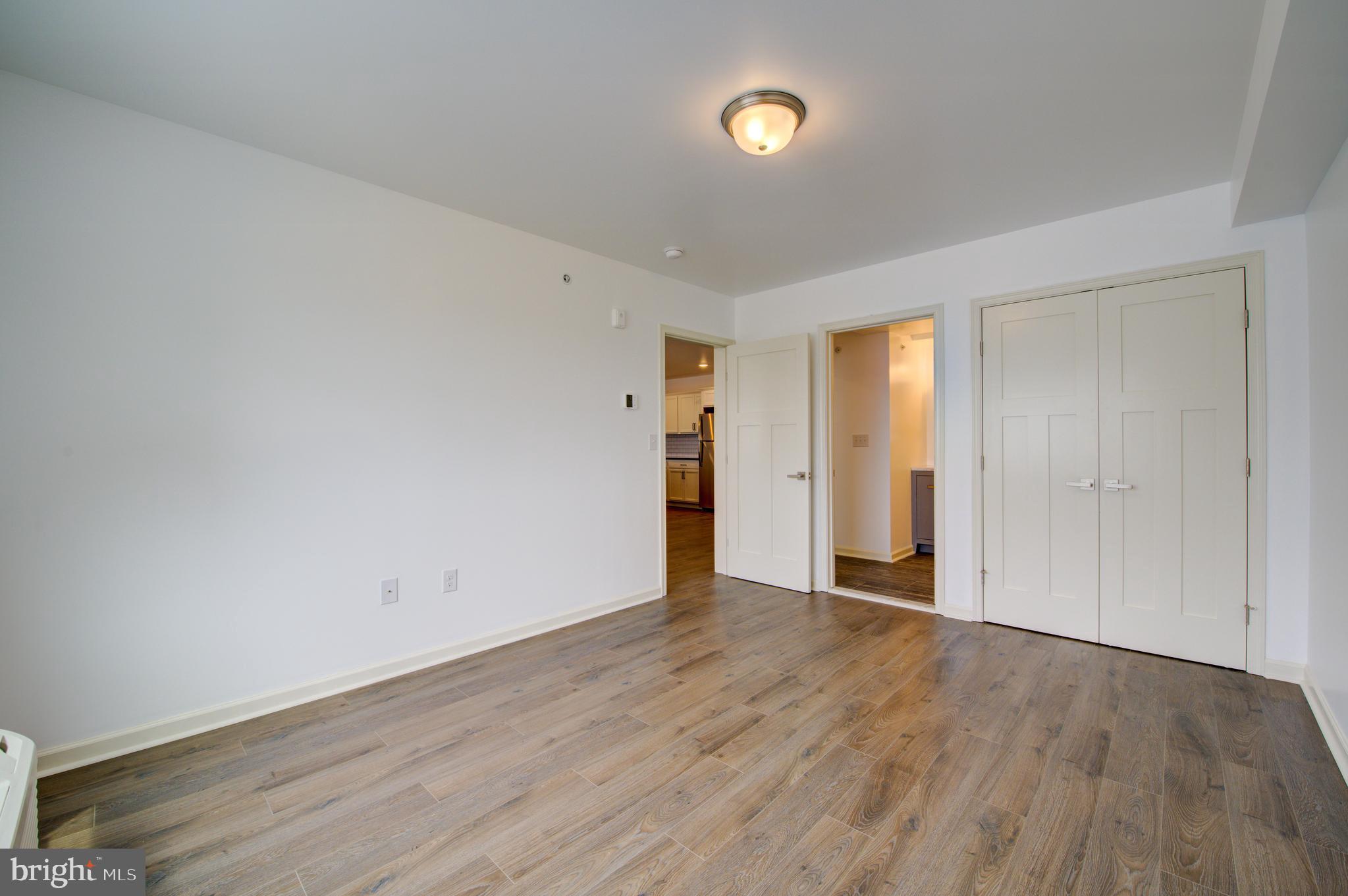 6649 Ridge Avenue, Unit B201 Philadelphia, PA 19128 - Photo 11 of 12 a view of an empty room with wooden floor and closet
