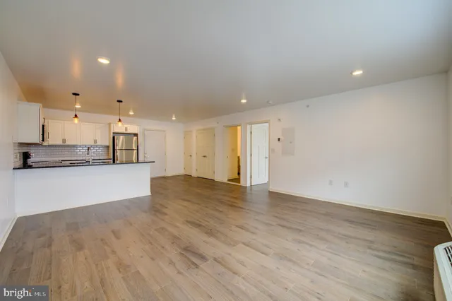 a view of kitchen with kitchen island and wooden floor