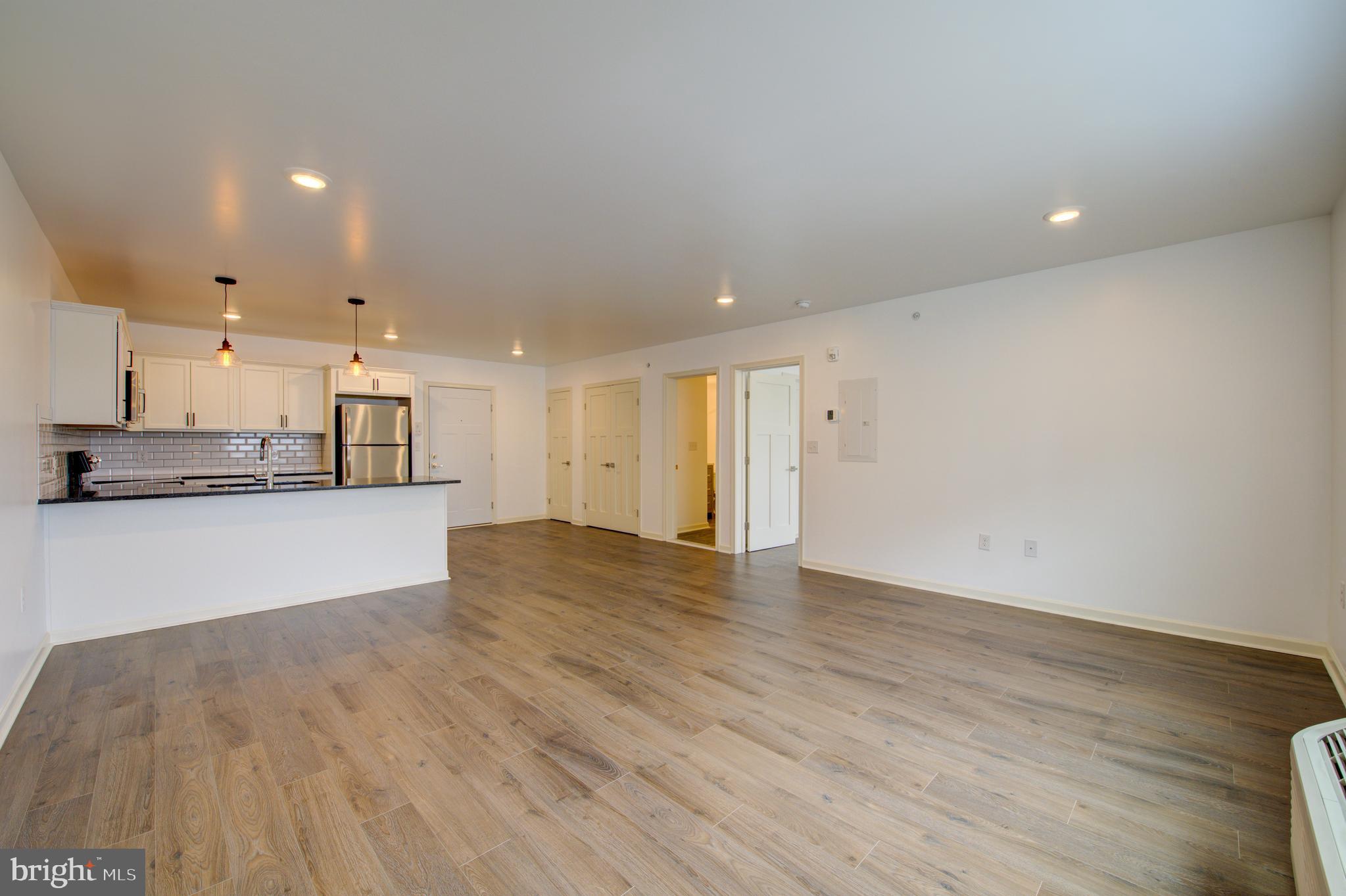 6649 Ridge Avenue, Unit B201 Philadelphia, PA 19128 - Photo 8 of 12 a view of kitchen with kitchen island and wooden floor