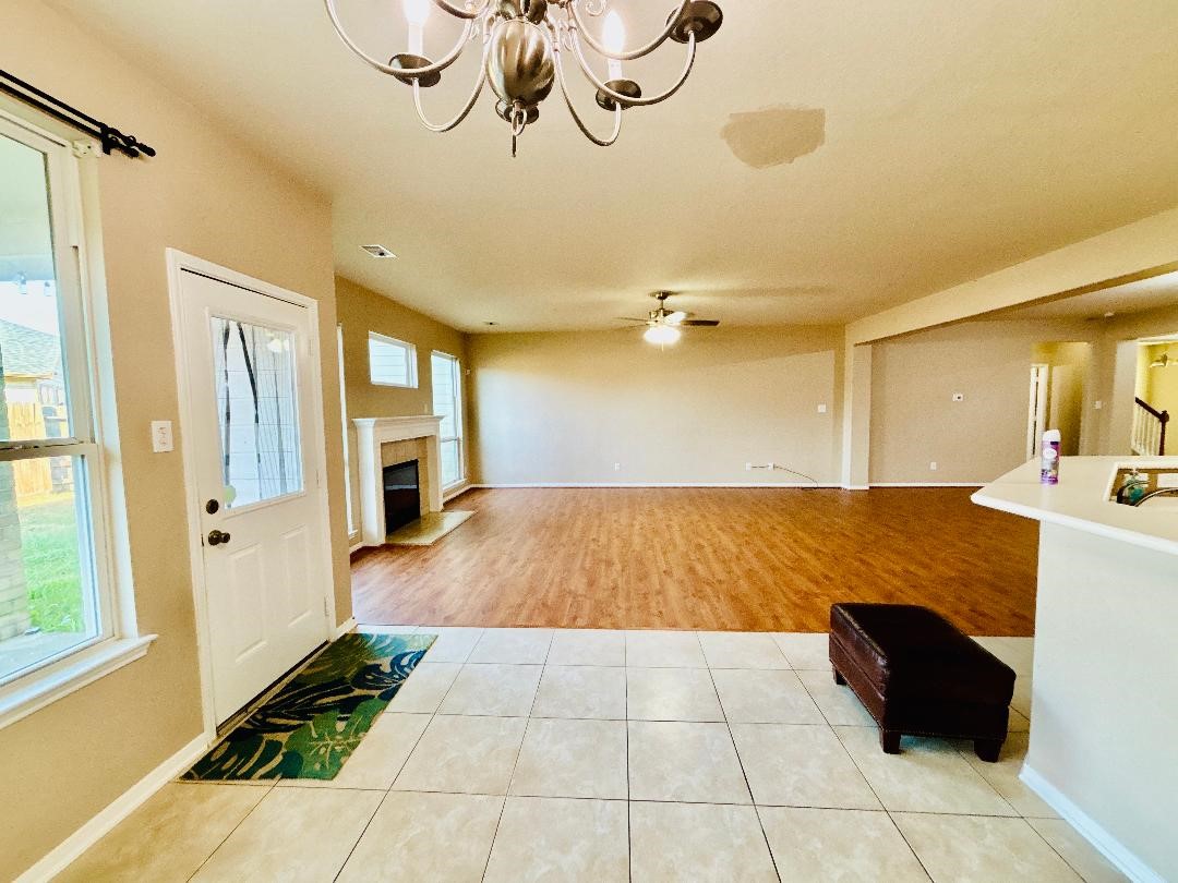 9947 Valance Way Conroe, TX 77385 - Photo 11 of 48 a view of a room with wooden floor and windows