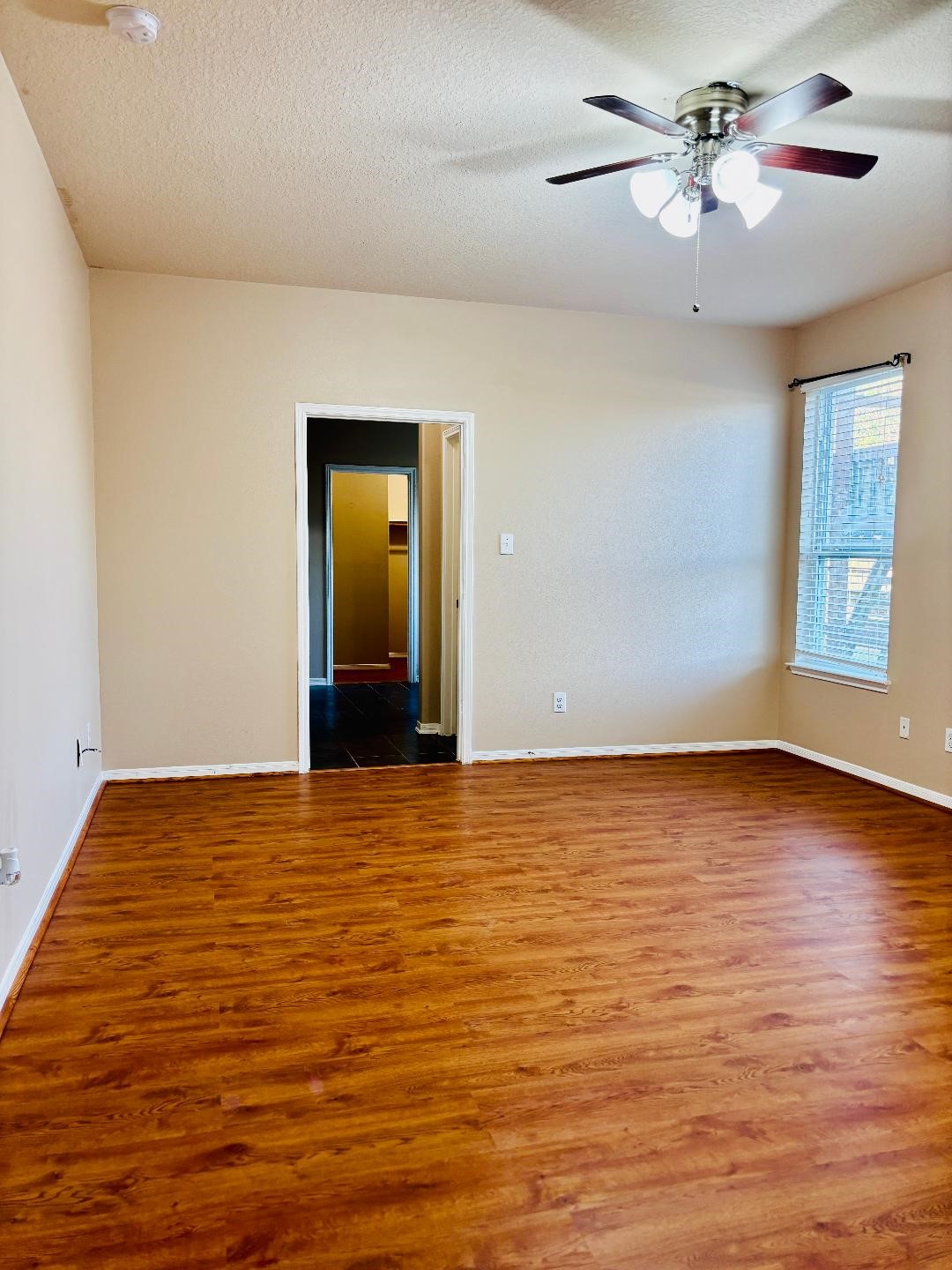 9947 Valance Way Conroe, TX 77385 - Photo 15 of 48 a view of an empty room with window and wooden floor