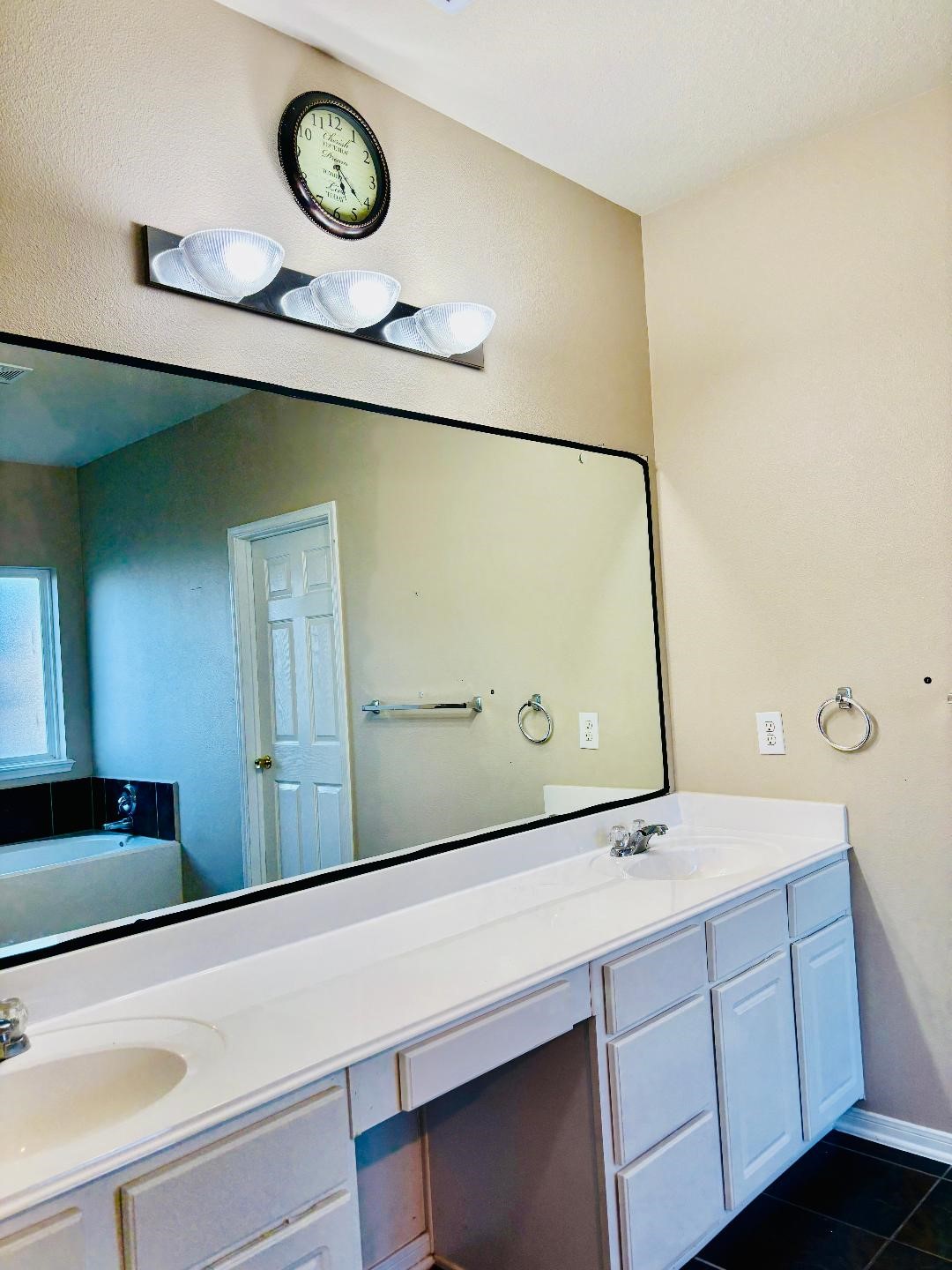 9947 Valance Way Conroe, TX 77385 - Photo 17 of 48 a bathroom with a sink and a mirror