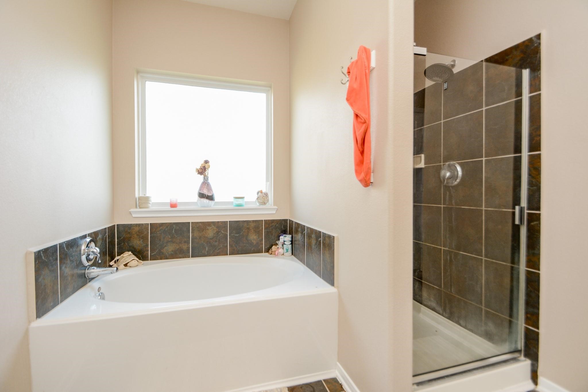 9947 Valance Way Conroe, TX 77385 - Photo 18 of 48 a bathroom with a bath tub and a shower