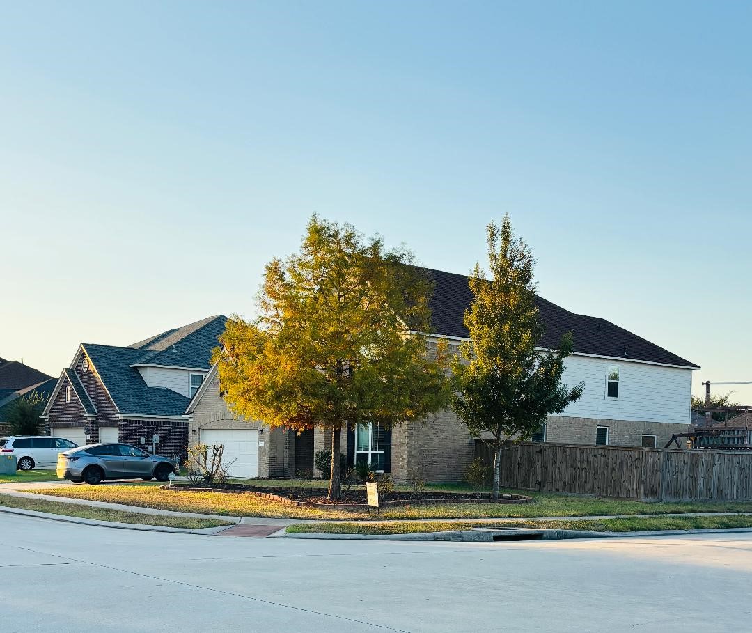 9947 Valance Way Conroe, TX 77385 - Photo 3 of 48 a front view of a house with a yard