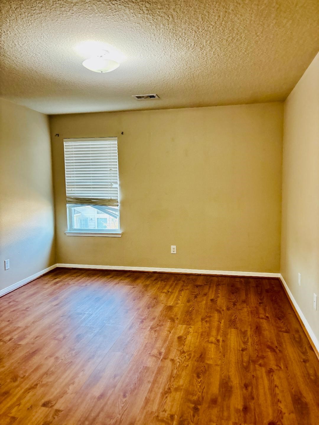 9947 Valance Way Conroe, TX 77385 - Photo 33 of 48 an empty room with wooden floor and windows