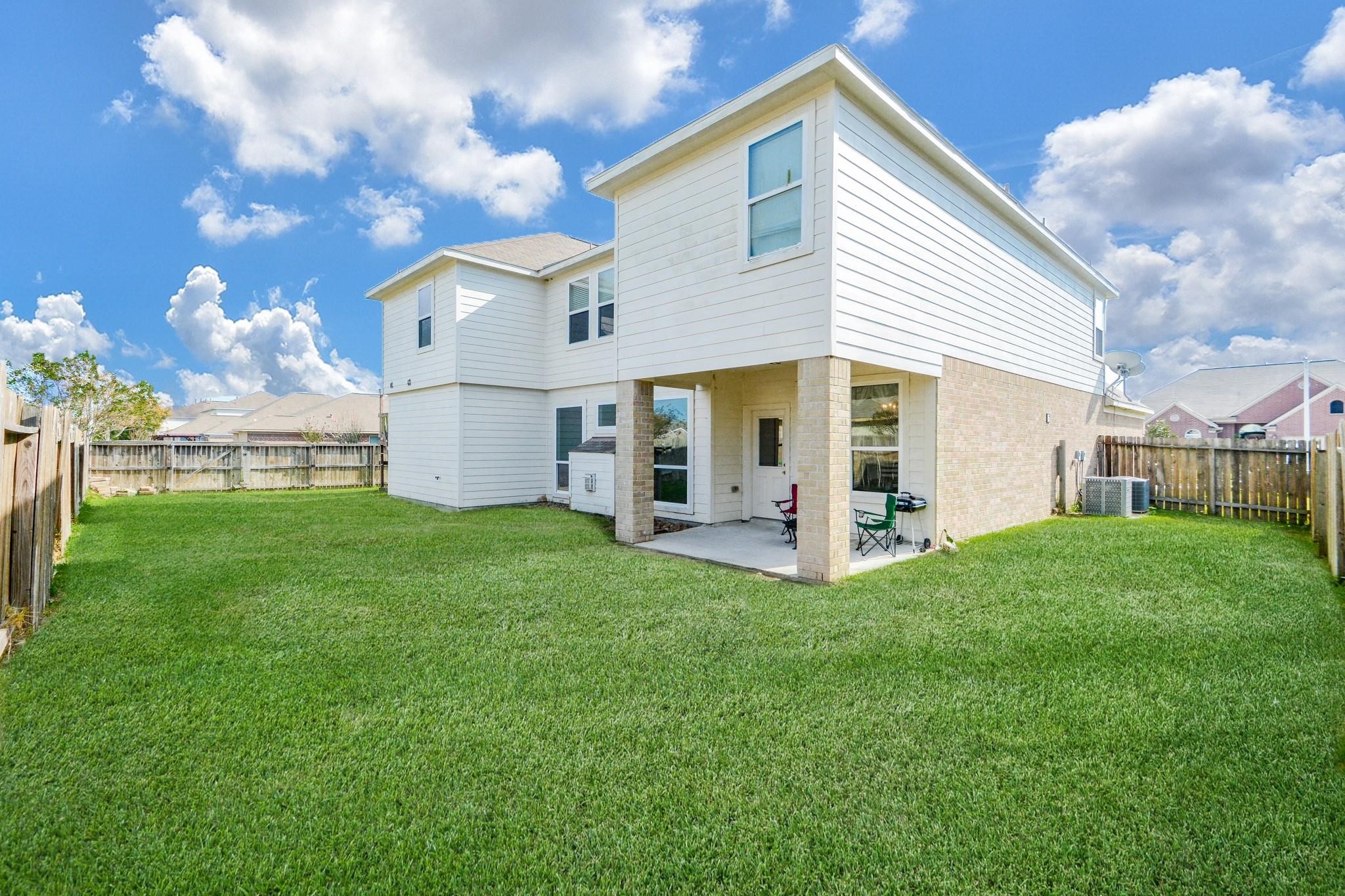 9947 Valance Way Conroe, TX 77385 - Photo 46 of 48 a view of a house with a yard