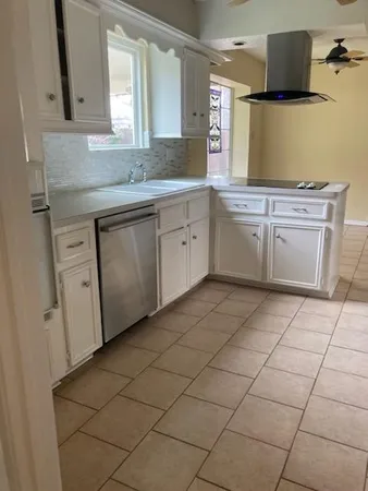 a bathroom with a granite countertop sink a toilet and a mirror
