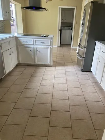 a room with a sink and cabinets