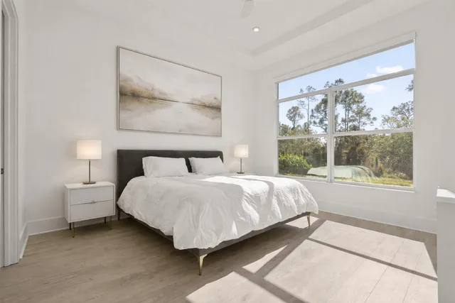 a bedroom with a bed lamp and window