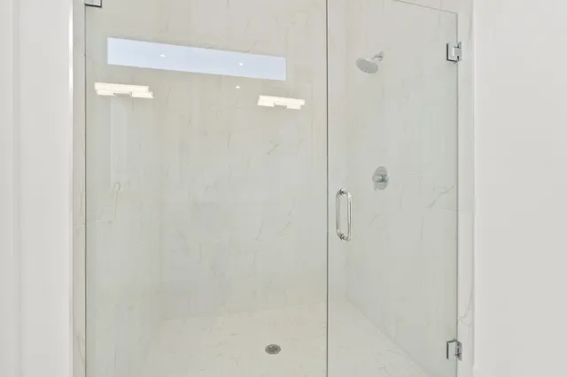 a bathroom with a glass shower door