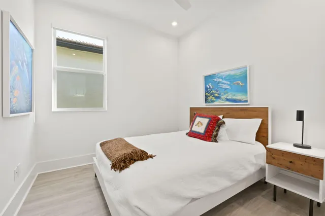 a bedroom with a bed and a painting on the wall