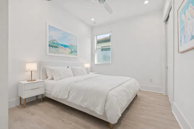 a bedroom with a bed and a painting on the wall