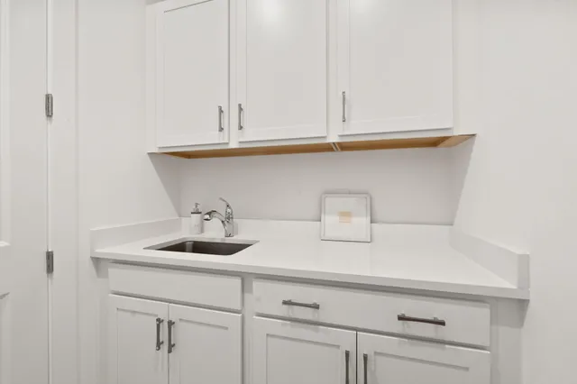 a kitchen with a sink and cabinets