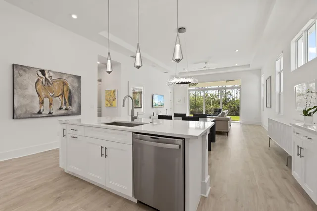 a kitchen with white cabinets and sink