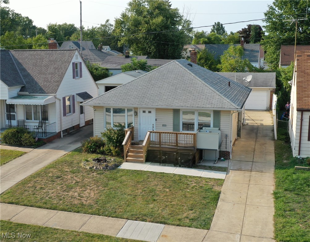 11913 Derby Road Cleveland, OH 44125 - Photo 1 of 28 Bungalow-style house with a garage, a front lawn, and an outbuilding
