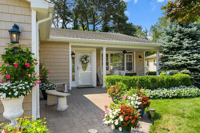 a front view of a house with a yard and fountain