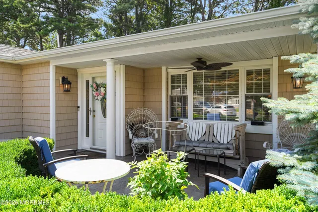 a view of a chair and table in back yard of the house