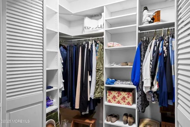 a view of a livingroom with workspace and a window