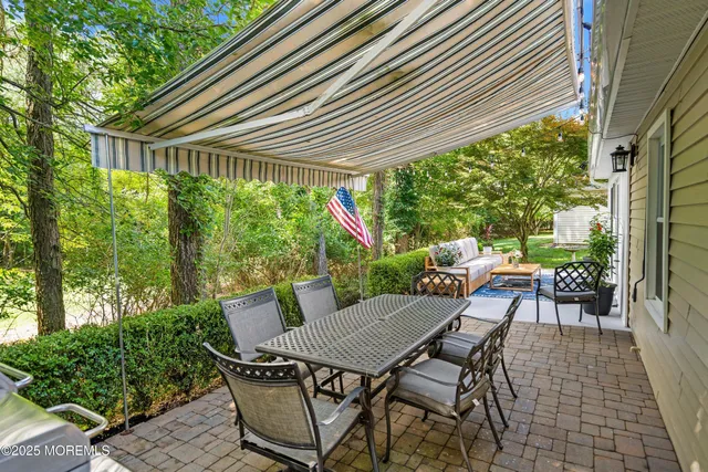 a backyard of a house with table and chairs