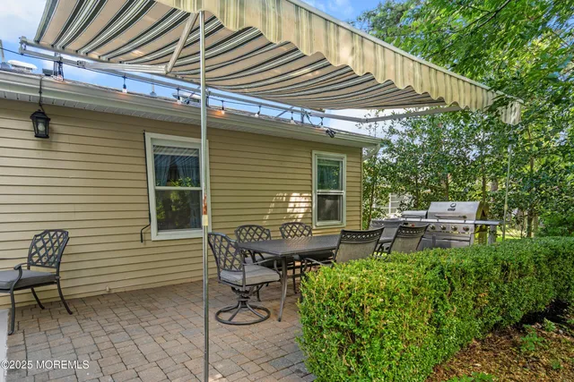 a view of a patio with table and chairs and potted plants