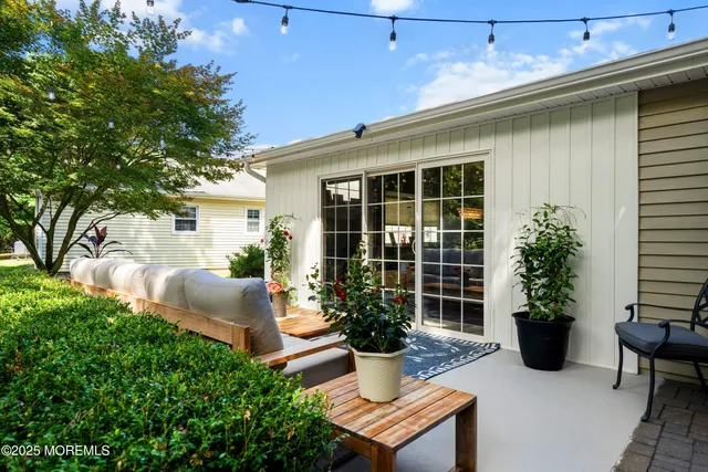 a view of a house with backyard and sitting area
