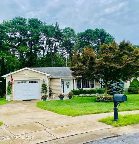 a front view of house with yard and green space