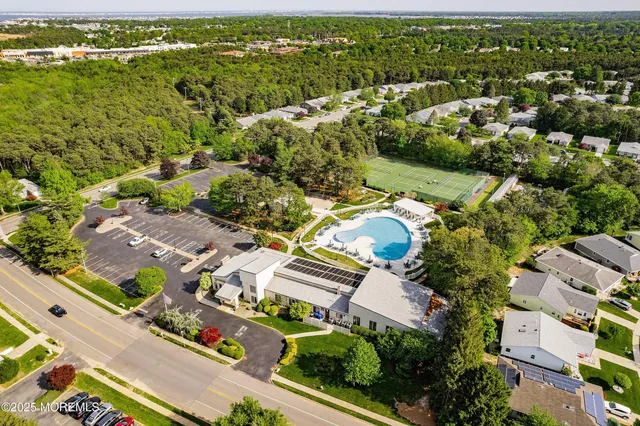 a view of a house with a big yard plants and large trees
