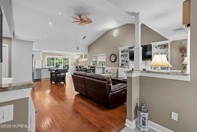 a living room with furniture a flat screen tv and a fireplace