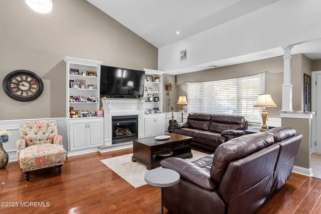 a kitchen with stainless steel appliances granite countertop a table chairs stove and refrigerator